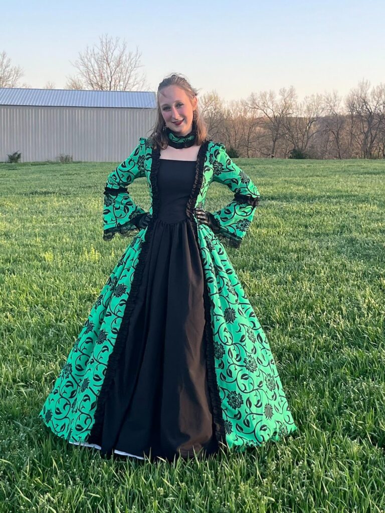 This dress is really great for what you're paying! It looks great and has lasted through several events so far. It's lightweight and ready to put on, and I was very happy with the look! Be aware that you'll need a crinoline skirt or something similar to get the pouf in the skirt. There's also a zipper on the side so that you can get it on and off. Be carful to not pull too hard on the lacing on the back as the loops aren't particularly strong (I accidentally sat on the end of mine and had to fix the loops I ripped)